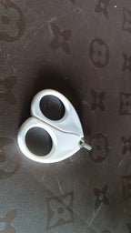 Close-up of baby safety nail cutter scissors showing circular blade