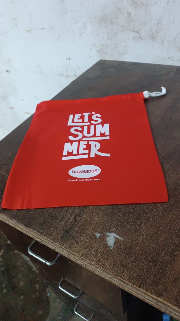 Clothes stored neatly inside a red drawstring bag, perfect for travel.