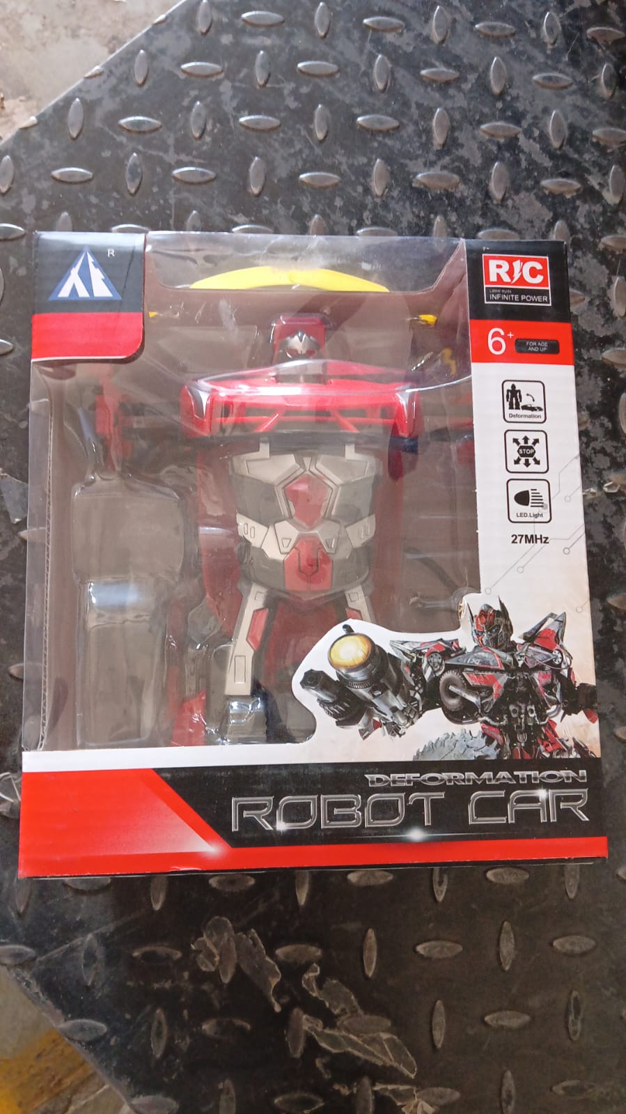 The remote control unit for the transforming robot car, showing intuitive buttons.