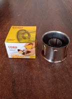Hand demonstrating the safe and easy use of the stainless steel corn cutter.