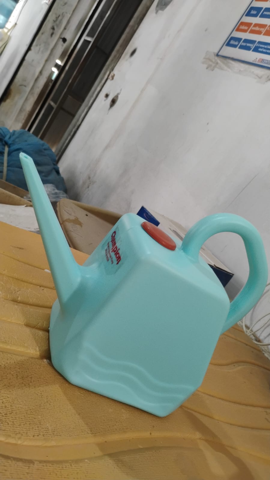 Plastic gardening watering can with long spout designed for gentle root watering