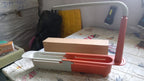 Another angle of the grey plastic telescopic sink storage rack, highlighting its sturdy design.