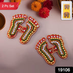 Close-up of Devi Steps Rangoli Charan stickers featuring vibrant stones and swirl patterns