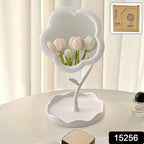 Side view of rotatable flower vanity mirror sitting on a tabletop