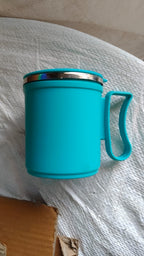Lifestyle shot of an insulated coffee mug on a desk, perfect for office use.