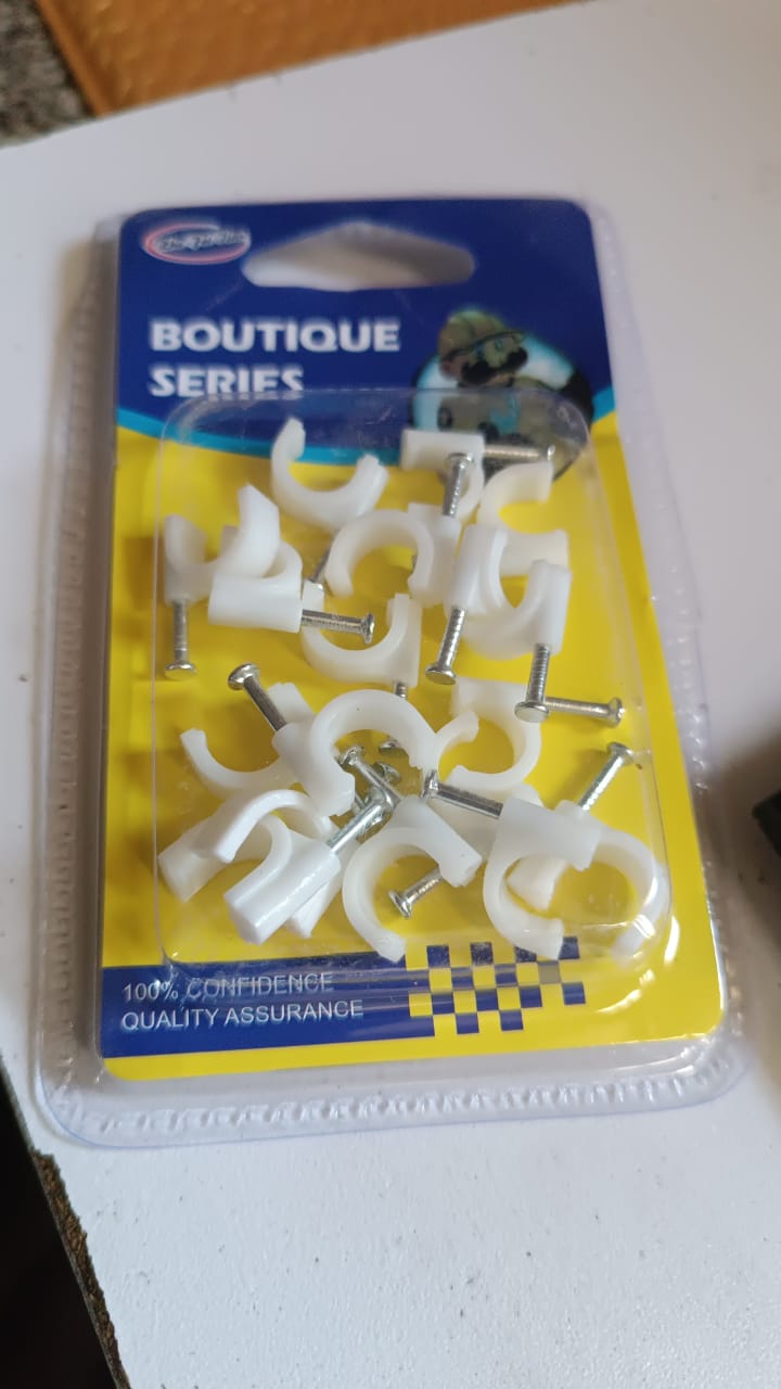 Various plastic cable clips display showing steel nail wire holders in a batch