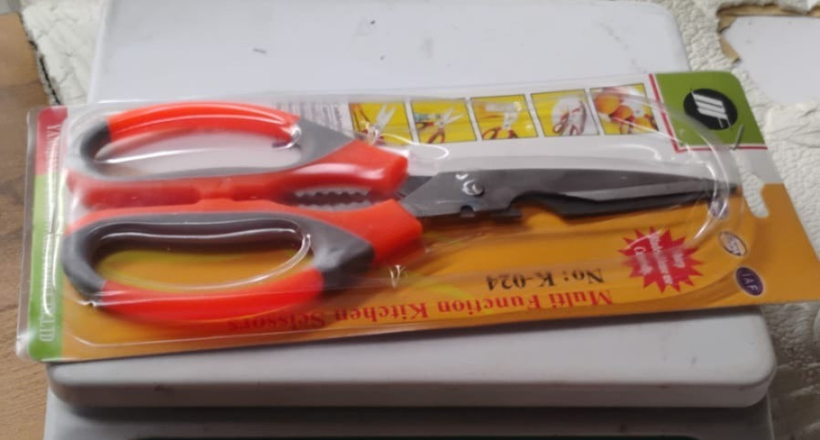 Multi-function kitchen scissors displayed with their packaging, ready for use in an Indian kitchen.