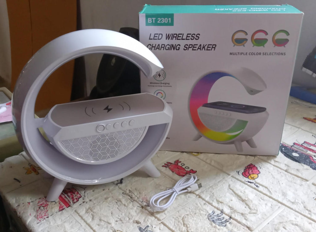 Stylish LED night lamp functioning as a Bluetooth speaker and charger.