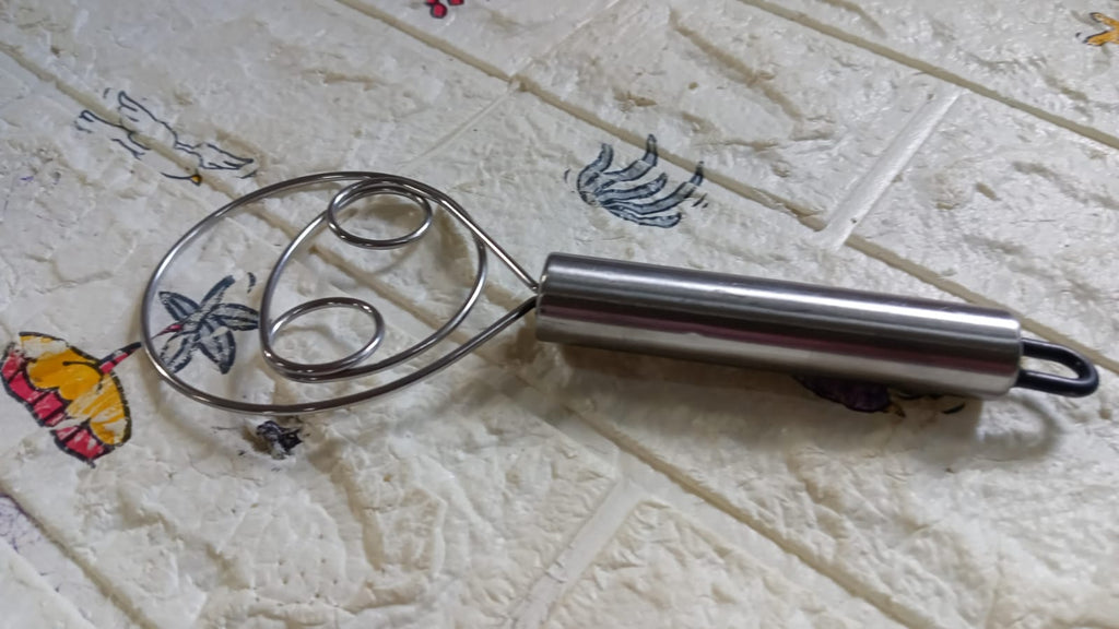 Dough whisk in action, mixing batter smoothly in a modern kitchen.