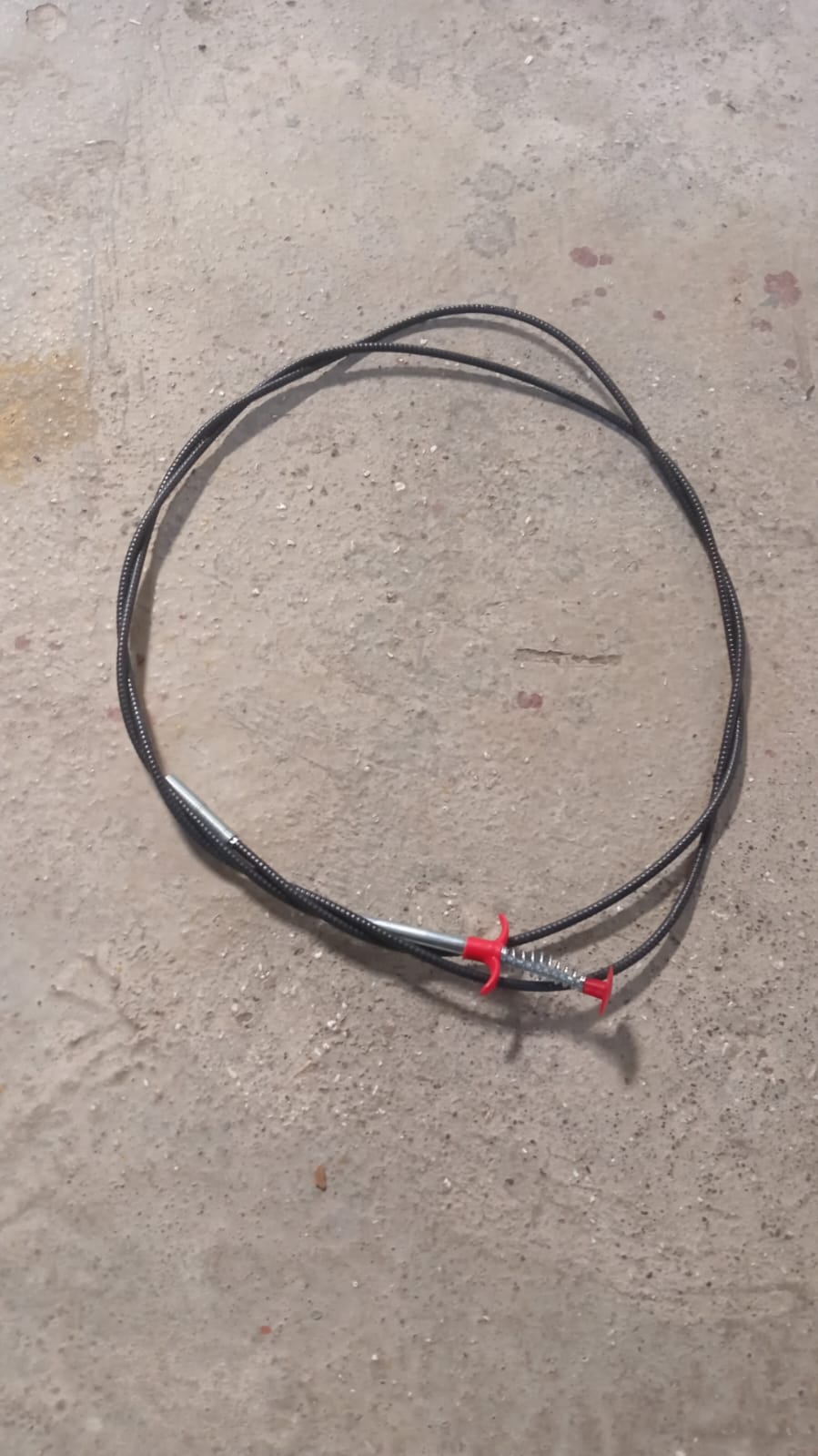 The effective drain cleaner tool with its spring and claw, designed for easy clog removal.
