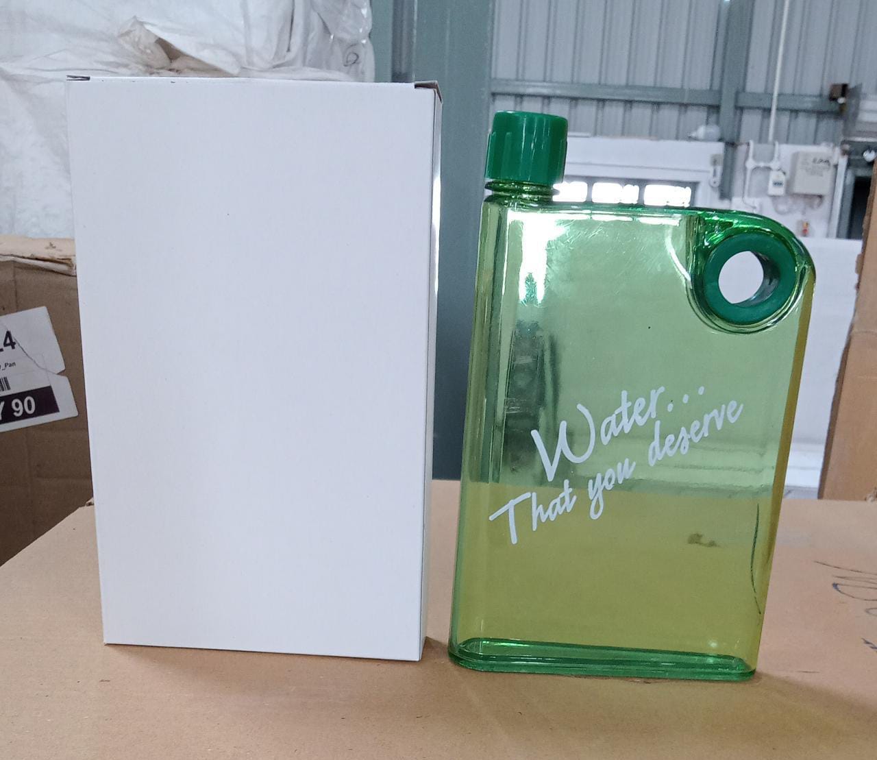 A transparent green slim water bottle, highlighting the clear plastic and vibrant color.