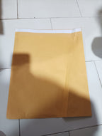 Several brown kraft envelopes lying flat on a table, showcasing their texture.
