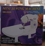 Top-down view of the compact sewing machine with its thread setup.