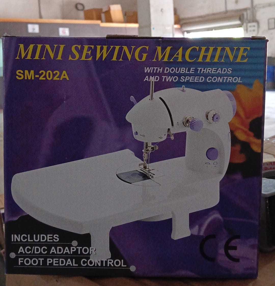 Top-down view of the compact sewing machine with its thread setup.
