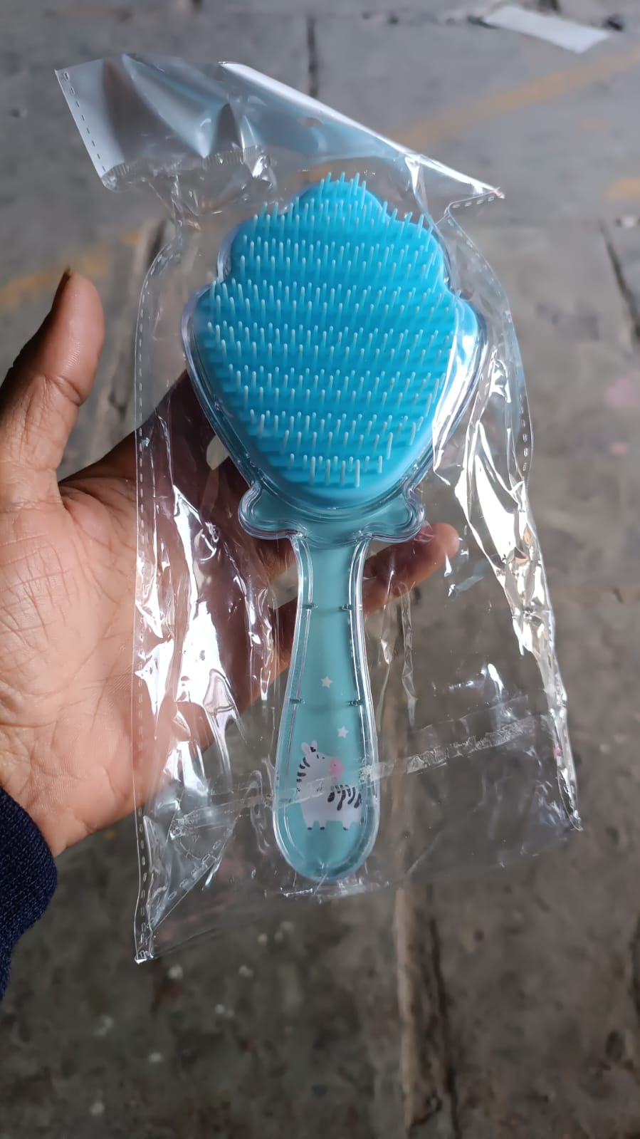 Packaging of the cartoon hair brush, emphasizing its suitability for children and ease of use.