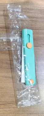 Teal green phone finger holder used to hang smartphone on hook