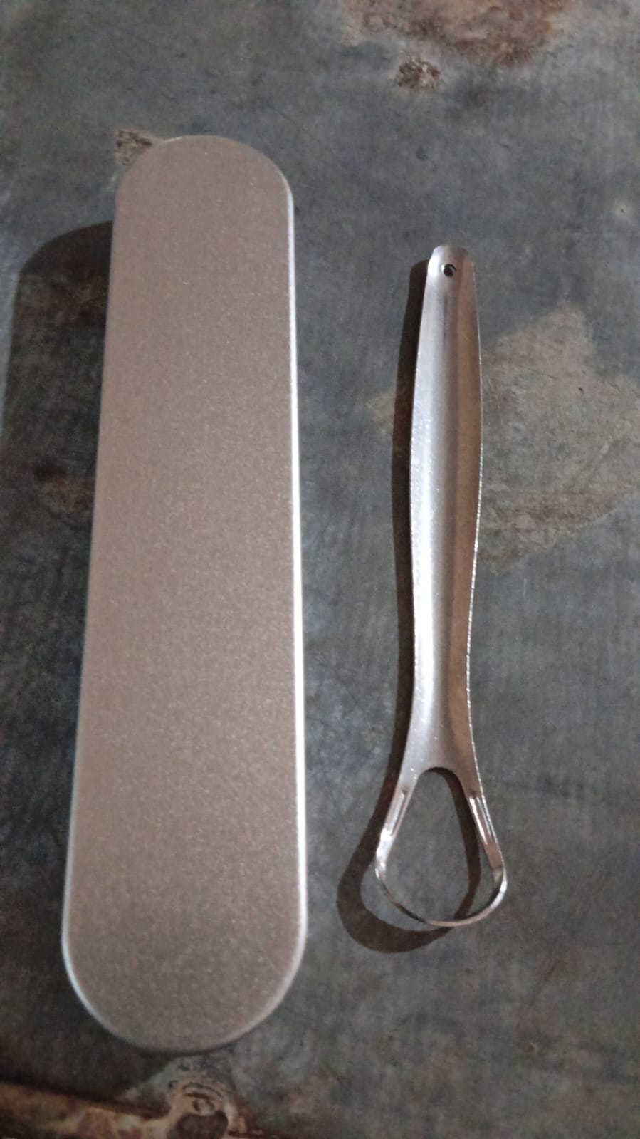 Packaging for the MintGuard stainless steel tongue scraper.