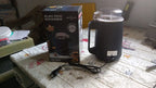 Dabster electric grinder surrounded by a vibrant selection of whole spices and coffee beans.