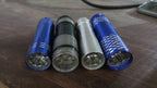 The mini LED flashlight illuminating a dark indoor space, demonstrating its bright beam.