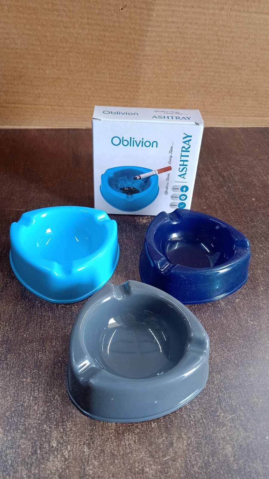 Angled view of plastic ashtray on wooden table