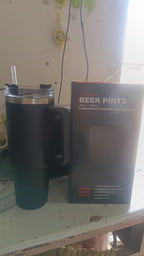 Angled view of stainless steel travel mug with lid and handle visible