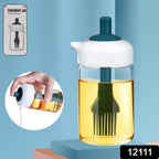 Close-up of the borosilicate glass oil dispenser with its integrated silicone brush.