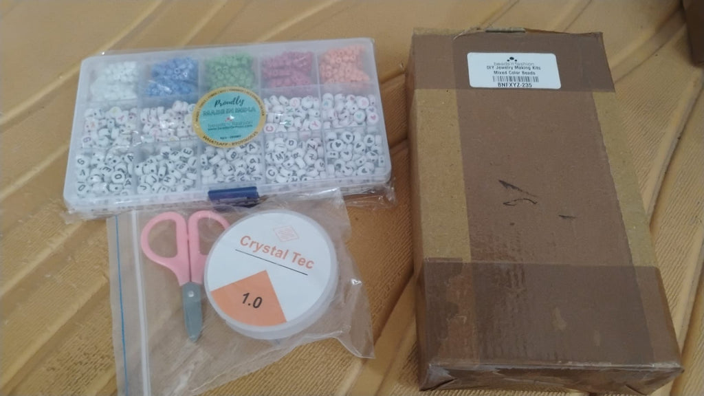 Neatly organized DIY bracelet making kit in a clear storage box