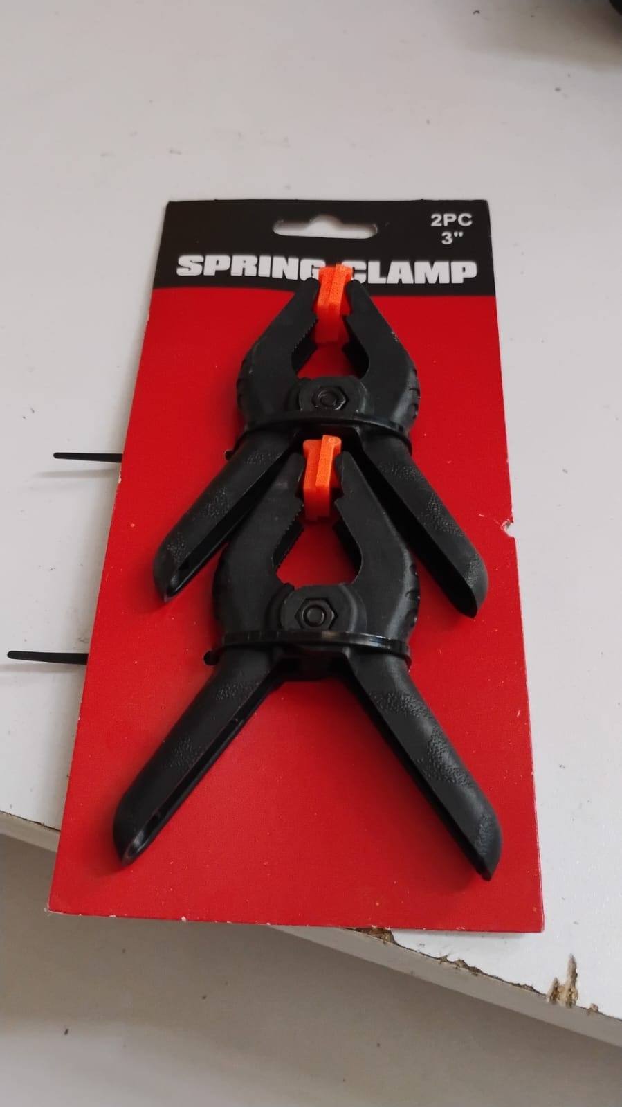 Two heavy-duty spring clamp tools on a white background, ready for screen repairs.
