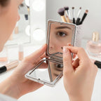 Compact foldable mirror keychain showcasing portable handheld feature