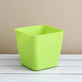 Vibrant square plastic flower pot for indoor or outdoor gardening.