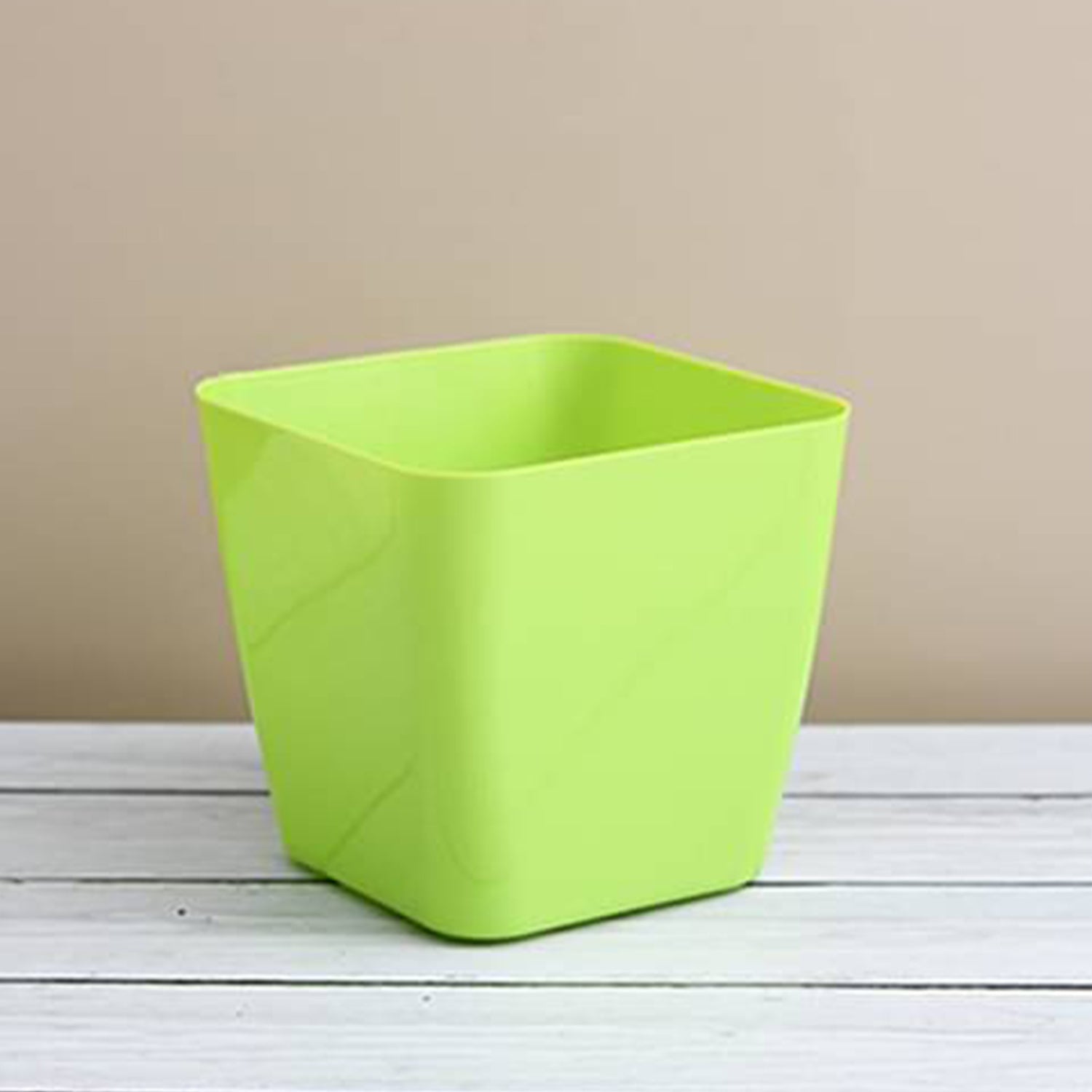 Vibrant square plastic flower pot for indoor or outdoor gardening.