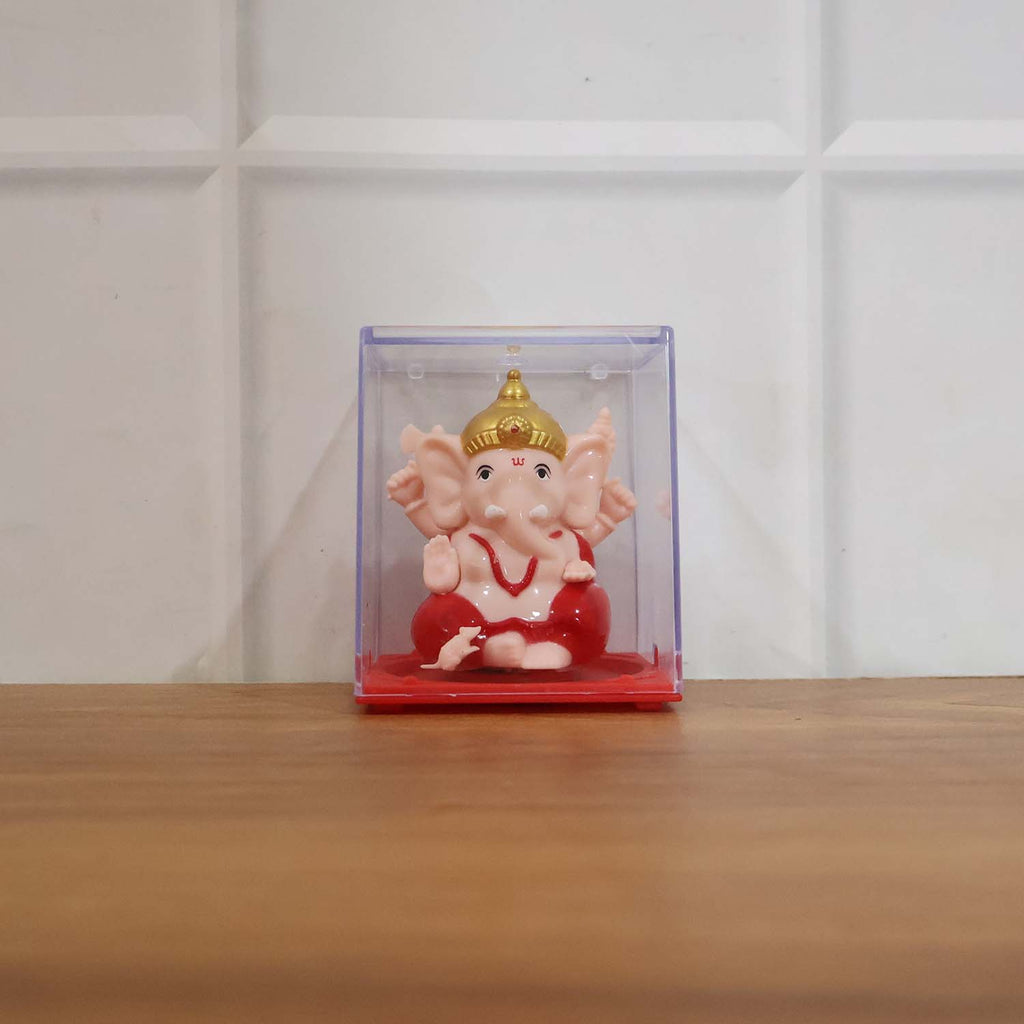 Back view of small red and gold Ganesha decorative statue