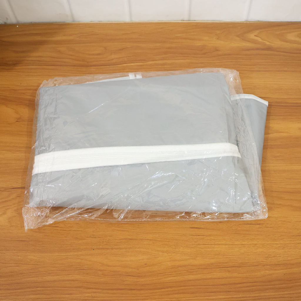Person placing a suit inside a breathable garment cover for protection