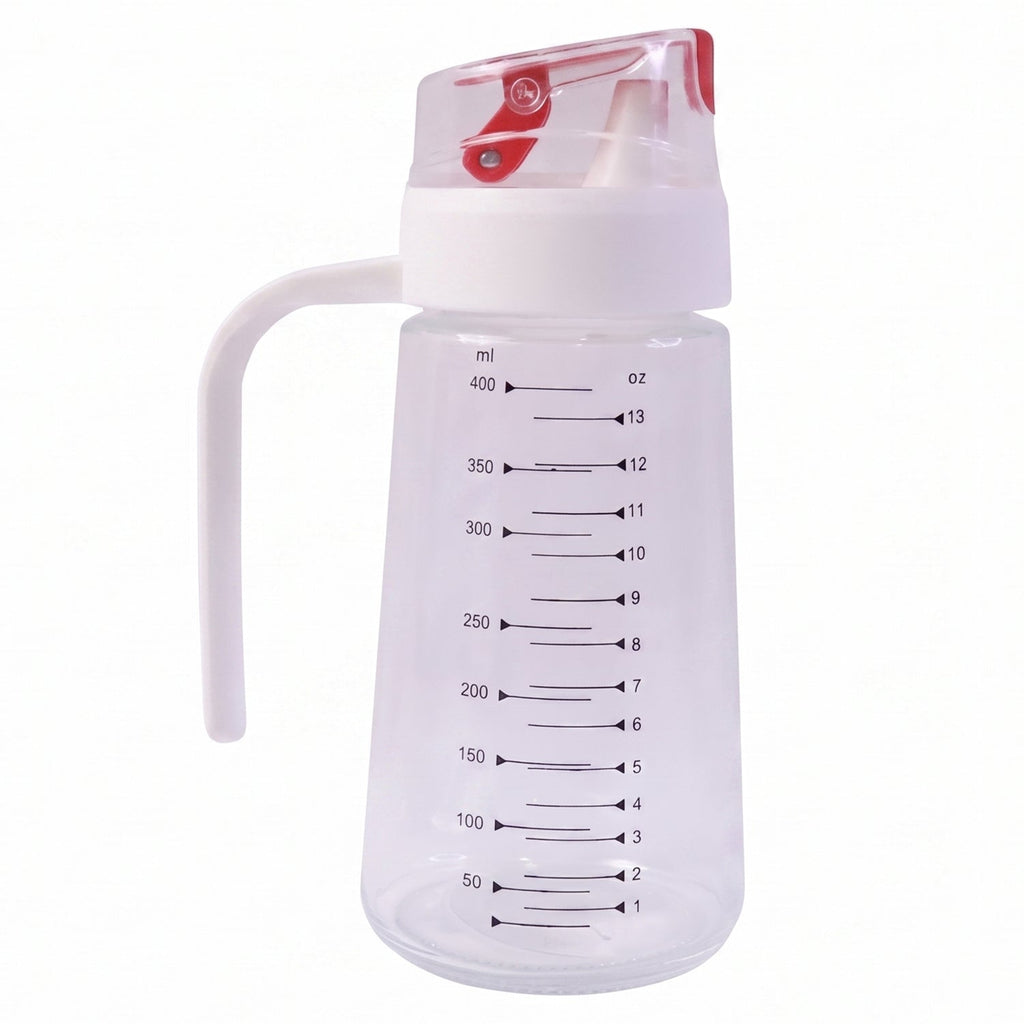Clear 500ml glass oil dispenser with white handle and red auto-flip cap on white background