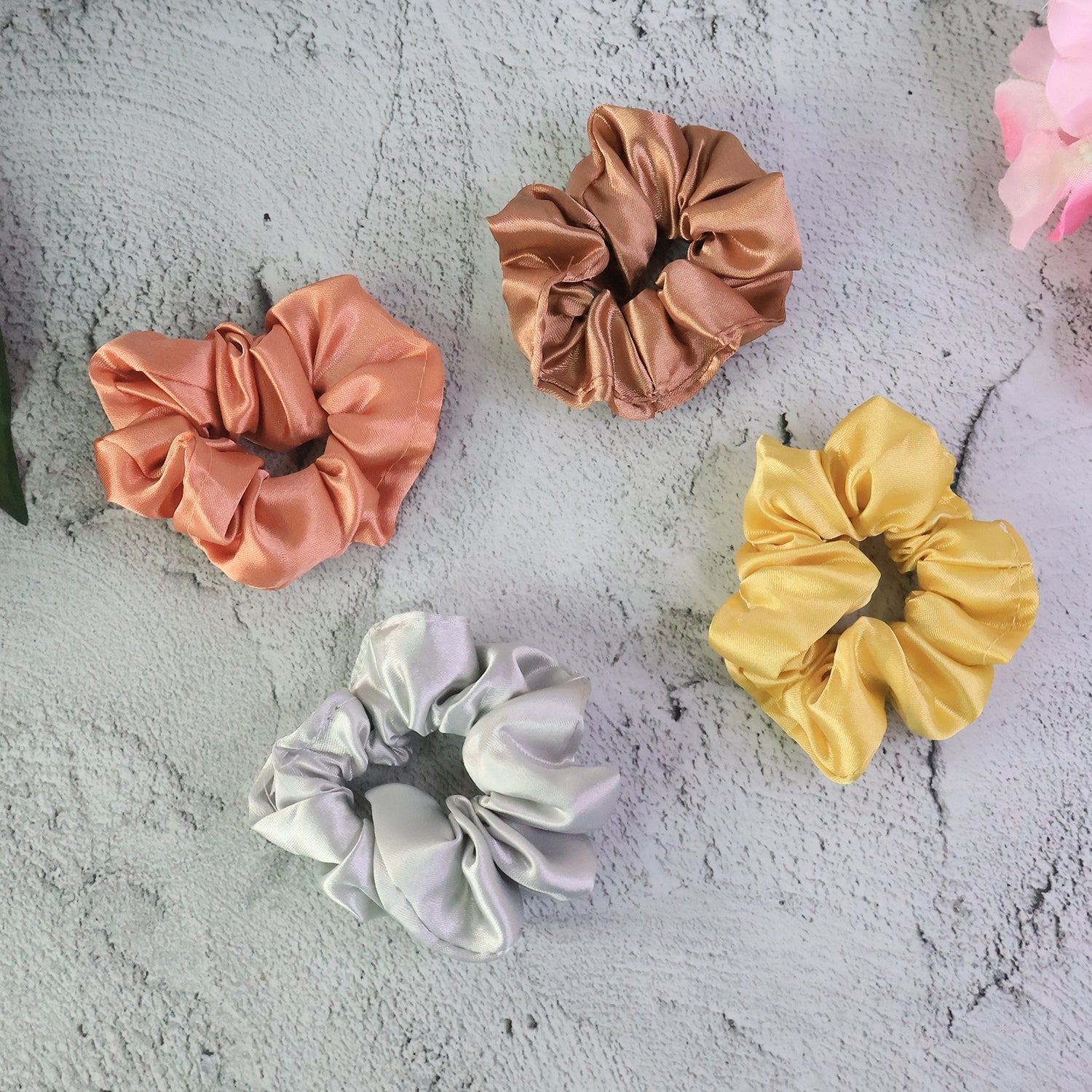 Assorted satin hair scrunchies neatly displayed on a light surface