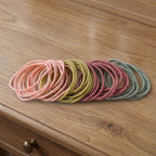 Collection of elastic hair bands in neutral shades, lightweight for daily wear