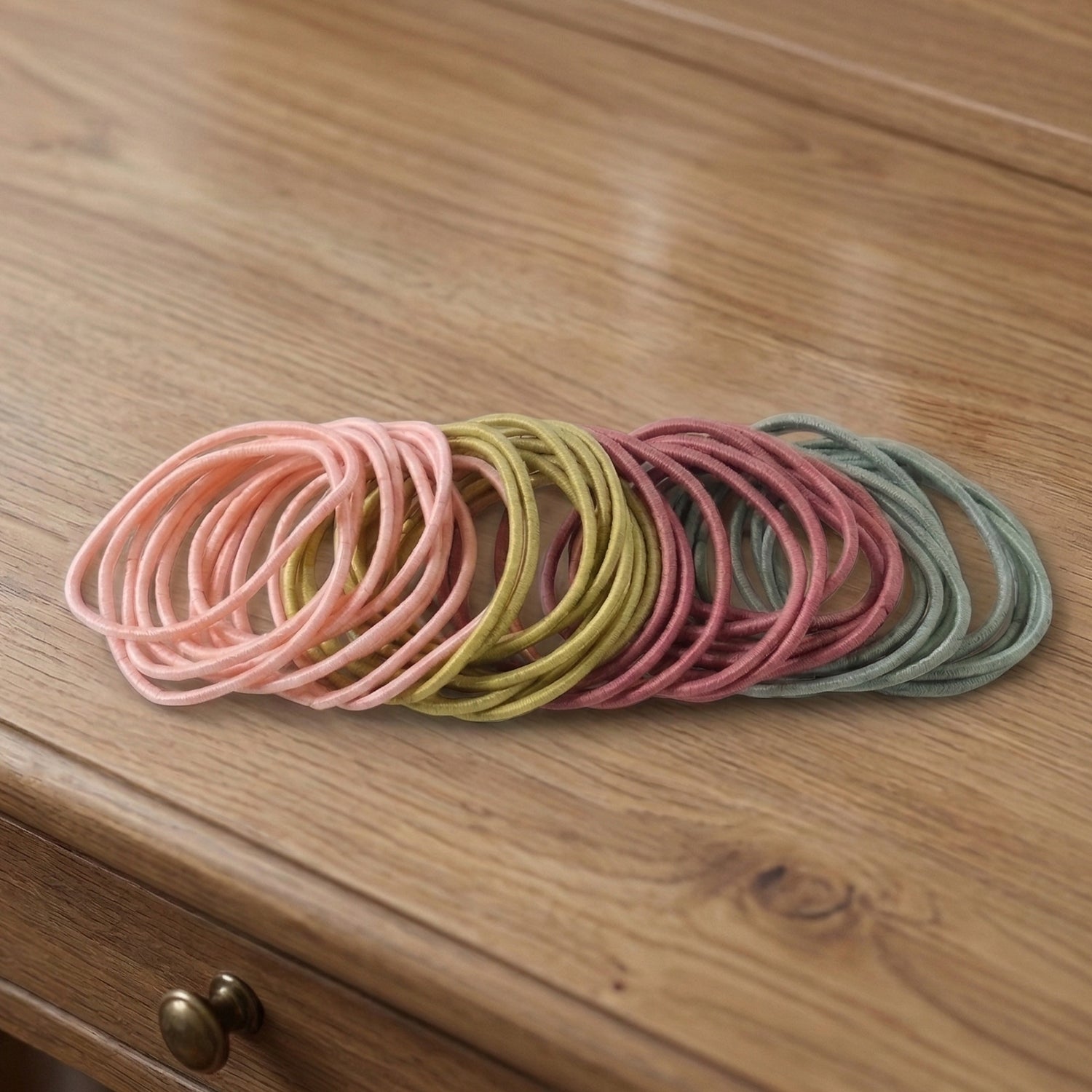 Collection of elastic hair bands in neutral shades, lightweight for daily wear