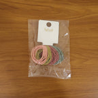 Lifestyle shot of elastic hair bands in use, soft and secure hold