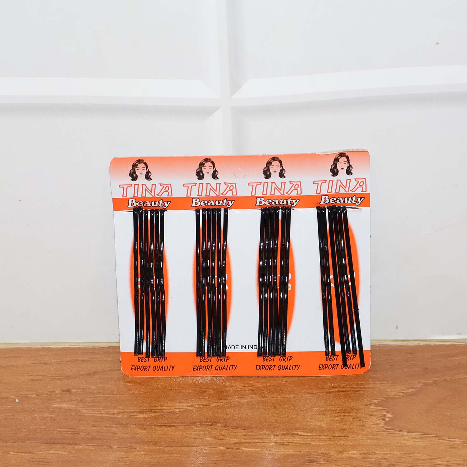 Lifestyle image of black hair bobby pins used in an elegant bun hairstyle