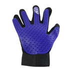 A person using the flexible deshedding glove to comfort and groom their cat.