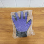 A real-time action shot of the pet deshedding glove removing loose fur from a pet.