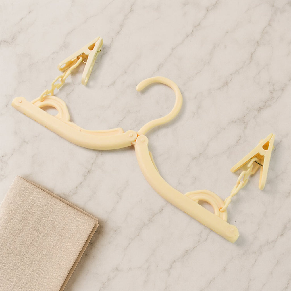 Foldable cloth hanger features strong clips to prevent slipping during drying