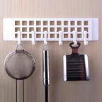Practical plastic hanger hook mounted on a wooden wardrobe door, ready for use.