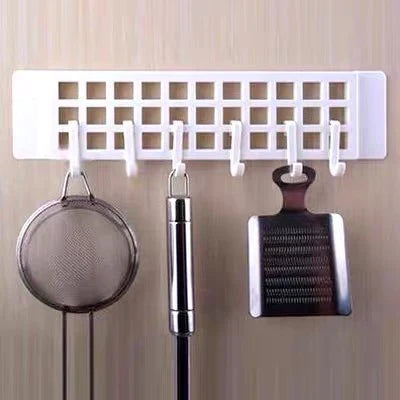 Practical plastic hanger hook mounted on a wooden wardrobe door, ready for use.