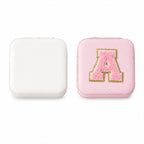 The LilyGleam travel jewellery box placed next to travel essentials like a passport and sunglasses.