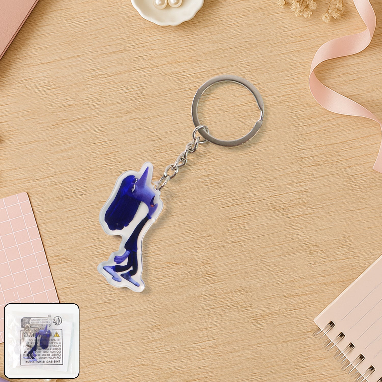 Glossy cartoon character acrylic keychain with fun expression attached to keyring