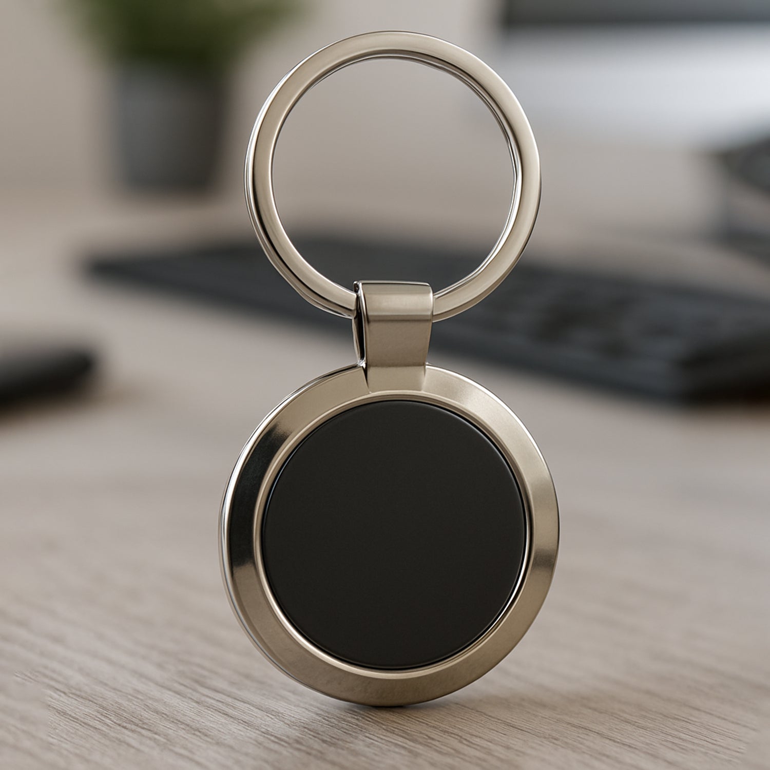 Black and chrome metal keychain in round shape for keys and accessories.