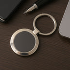 Durable round metal keychain with strong alloy build and black center.