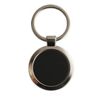Classic round key ring featuring a chrome border with black center insert.