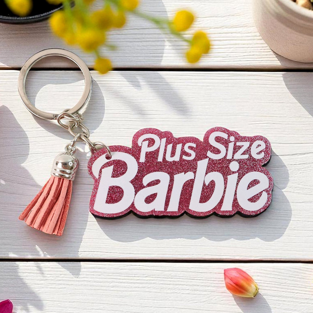 Close up of plus size barbie glitter keychain with tassel charm